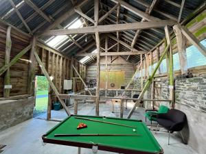 a barn with a pool table in it at Drovers Retreat in Llandrindod Wells