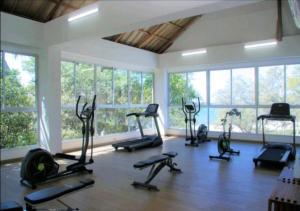 a gym with many exercise bikes in a room with windows at Best Luxury Samaria in Santa Marta