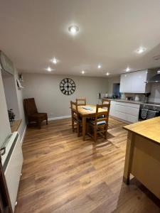 a kitchen and dining room with a table and chairs at North Coast Property - 17 Margaret Street - Avoch in Avoch