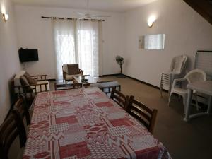 a dining room with a table with a red and white blanket on it at SW Villa Corail - Trou aux Biches in Trou aux Biches