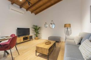een woonkamer met een bank, een tv en een tafel bij Los Adelantados La Hornacina Live Canarias in La Laguna