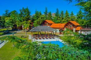 a house with a gazebo and a swimming pool at Hotel Villa Sol in Merlo