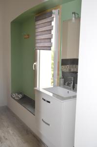 a bathroom with a sink and a mirror at MAS DE LA FORGE NOGUIER in Vergèze