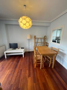 a living room with a table and a laptop computer at Azaraleku apartamento playa in Zarautz