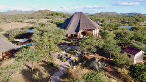 an overhead view of a house with a thatch roof at Privathaus mit eigenem Pool - Windhoek in Windhoek