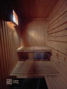 a wooden sauna with a wooden bench in it at Cozy cabin at Beitostølen with sauna, hot tub & fireplace in Beitostøl
