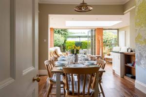 a dining room with a table and chairs at Surrey Lodge in Brockenhurst