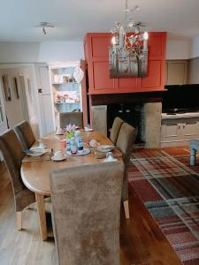 a dining room with a table with chairs and a fireplace at The White Dove Bed and Breakfast with Glamping Newark showground in Newark upon Trent