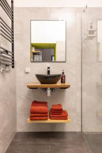 a bathroom with a sink and a mirror and towels at PASSAGE - historic boutique suite in Haarlem