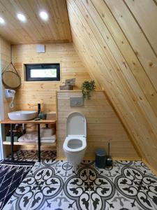 a bathroom with a toilet and a sink at Roots Svaneti ' რუთს სვანეთი in Lentekhi