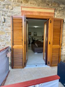 a door open to a living room with a couch at La Casa del Nonno in Torchiara +17 photos