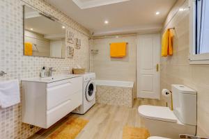 a bathroom with a sink and a washing machine at Ocean View Duplex Tenerife ( Golf del Sur) in San Miguel de Abona +16 photos