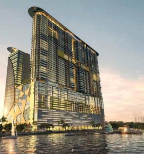 a large building on the water next to a river at Silverscape,Res -- Seaview -- Balcony -- 7 pax in Melaka