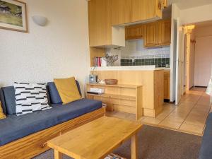 a living room with a couch and a kitchen at Appartement Montvalezan-La Rosière, 2 pièces, 5 personnes - FR-1-275-191 in Montvalezan