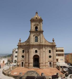 an old building with a bell tower on top of it at La casetta in Pomarico +3 photos