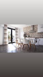 a kitchen with a table and chairs in a room at El Rincón de Agua Amarga 2 in Agua Amarga