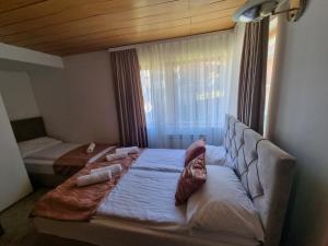 Postel nebo postele na pokoji v ubytování Pansion Rog Jahorina