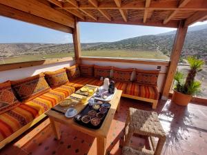 a living room with a couch and a table at Peak House Imsouane in Imsouane