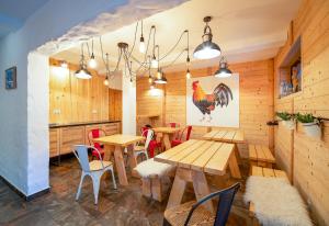 a restaurant with wooden walls and tables and chairs at Loft Apart View & Wellness in Szczyrk