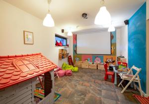 a room with a play room with a white screen at Loft Apart View & Wellness in Szczyrk