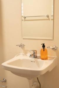 a bathroom sink with a soap dispenser on it at Amplia casa con 3 habitaciones para hospedaje in Chetumal