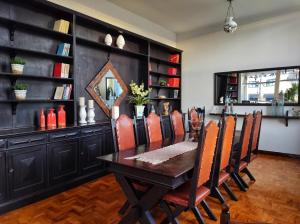 a dining room with a wooden table and chairs at Hotel Itarare in Itararé