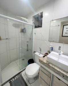 a bathroom with a toilet and a shower and a sink at Sol de Bora Bora in Salvador