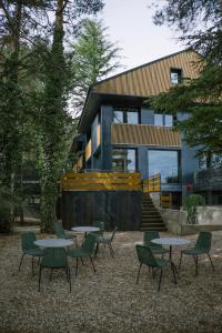 a group of tables and chairs in front of a building at BOX ART ALPINO in Navacerrada