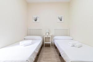 Łóżko lub łóżka w pokoju w obiekcie Allo Apartments Consistorio Centro 2 Habitaciones