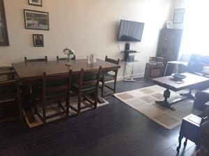 a living room with a wooden table and chairs at Flat near City Centre Liverpool 10 mins to Arena in Liverpool