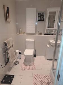 a white bathroom with a toilet and a sink at Flat near City Centre Liverpool 10 mins to Arena in Liverpool