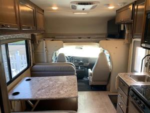 an interior view of an rv with a kitchen and a kitchen at AJ-XL RV Rental in Reseda