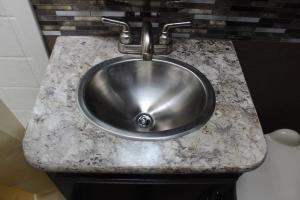 a stainless steel sink in a counter in a bathroom at AJ-XL RV Rental in Reseda