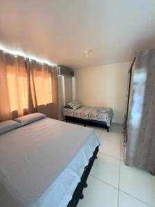 a bedroom with two beds in a room at Sol de Bora Bora 101 in Salvador