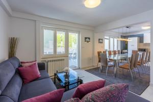 a living room with a couch and a table at House Moderna 2 in Crikvenica