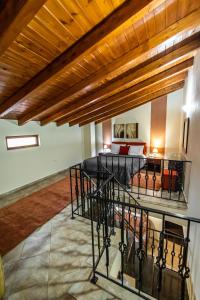 a living room with a wooden ceiling and a table at Enastron in Kalavrita