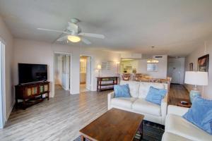 a living room with a white couch and a table at El Matador 544 - Beautiful water views and close to all amenities of El Matador in Fort Walton Beach