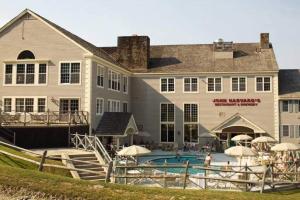 a large building with a swimming pool in front of it at Deluxe Ski On Off 1BR Suite Sleeps 4 on Jiminy Mtn in Hancock