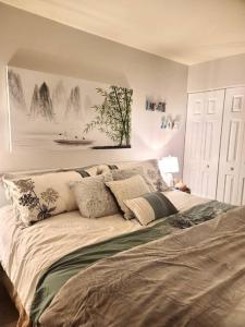 a bedroom with a large bed with pillows on it at Gorgeous New Zen Suite Sleeps 4-Ski On Off Jiminy in Hancock