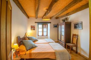 a bedroom with a large bed in a room at Casa Monaut, acogedores apartamentos a los pies de la selva de Irati in Saragüeta