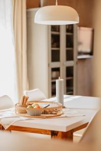 a table with a candle and a basket of bread at Holzmichel in Hullern +28 photos