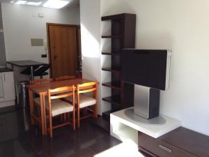 a dining room with a table and a television at Apartamentos Benicassim in Benicàssim