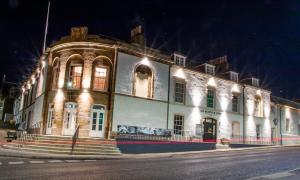 a lit up building on a street at night at The Seafield Arms-Cullen in Cullen