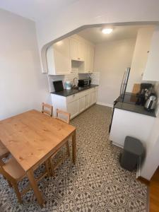 a small kitchen with a wooden table and a tableablish at Furnished Apartments - Climate Pledge Arena Next Door in Seattle