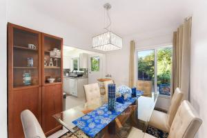 a dining room with a glass table and chairs at Amazing House In The Heart Of Vancouver DT/YVR/UBC in Vancouver