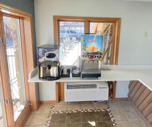 a kitchen counter with a coffee maker and a window at Super 8 by Wyndham Pigeon Forge Downtown in Pigeon Forge
