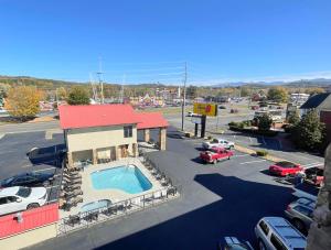 an aerial view of a parking lot with a pool at Super 8 by Wyndham Pigeon Forge Downtown in Pigeon Forge
