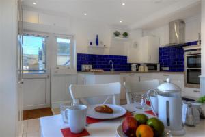 a kitchen with a table with a plate of fruit on it at 2 Mareeba in Seaton