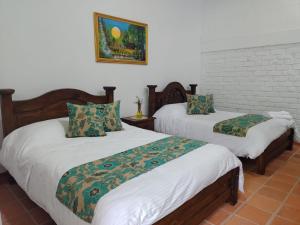 Postel nebo postele na pokoji v ubytování Casa Flórez Hotel Campestre