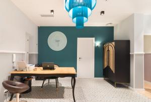 an office with a desk and a blue wall at Hostal Evocare Madrid in Madrid +76 photos